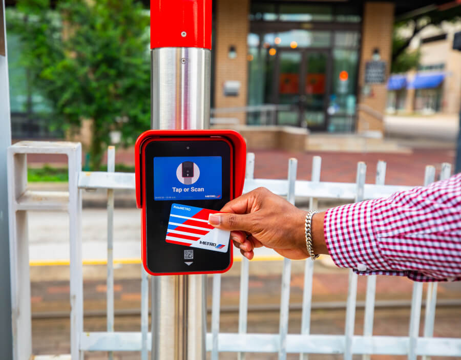 RideMETRO Fare Card being scanned on METRORail platform.